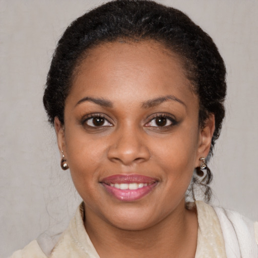 Joyful black young-adult female with medium  brown hair and brown eyes