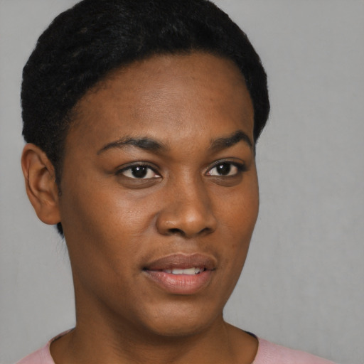 Joyful black young-adult female with short  black hair and brown eyes