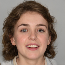 Joyful white young-adult female with medium  brown hair and blue eyes