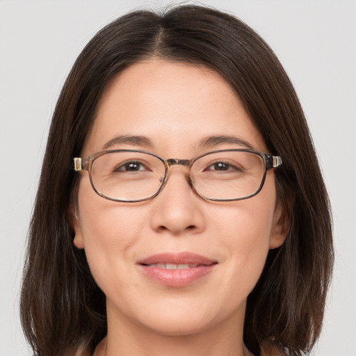 Joyful white adult female with medium  brown hair and brown eyes