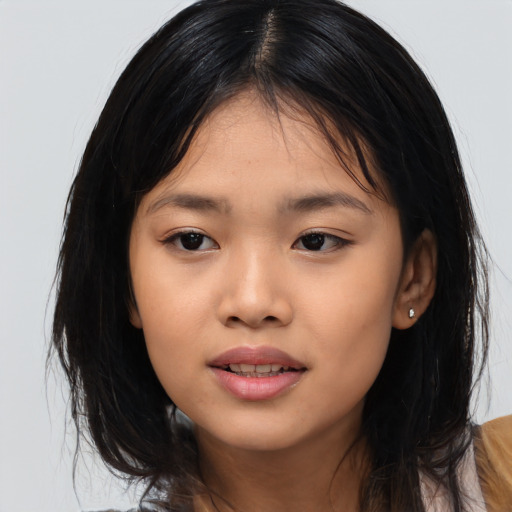Joyful asian child female with medium  brown hair and brown eyes