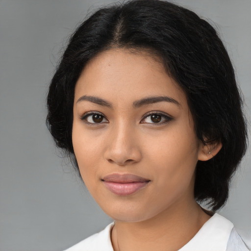 Joyful latino young-adult female with medium  black hair and brown eyes