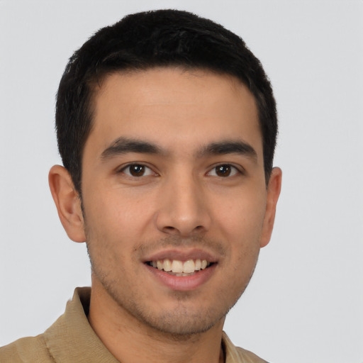 Joyful latino young-adult male with short  brown hair and brown eyes