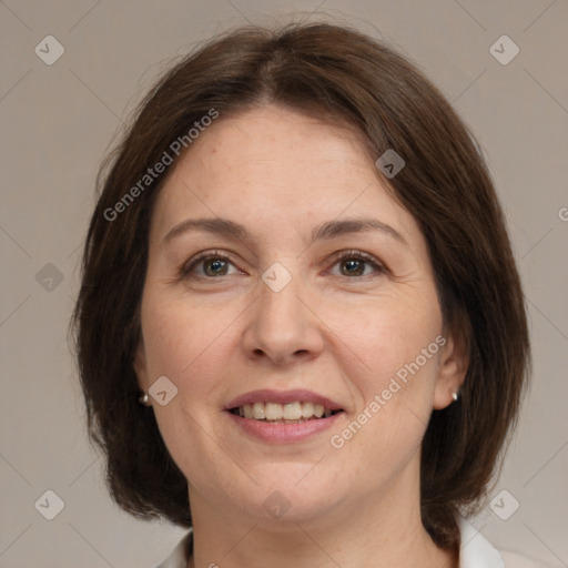 Joyful white adult female with medium  brown hair and grey eyes