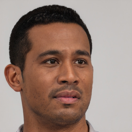 Neutral latino young-adult male with short  black hair and brown eyes