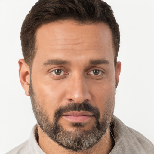 Joyful white adult male with short  brown hair and brown eyes