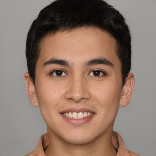 Joyful latino young-adult male with short  brown hair and brown eyes