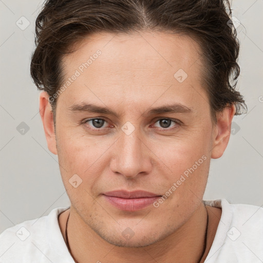 Joyful white young-adult male with short  brown hair and brown eyes