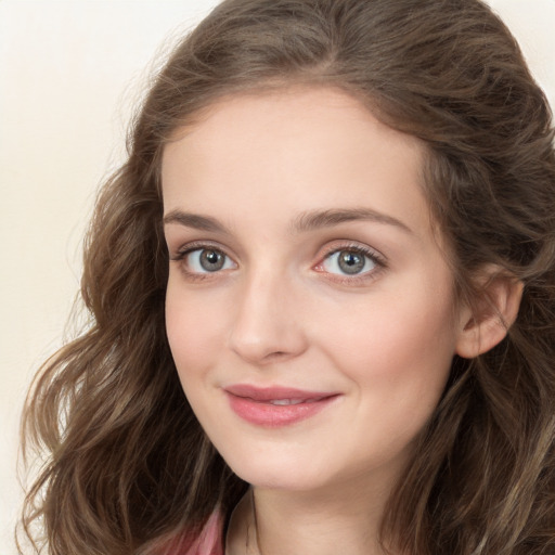 Joyful white young-adult female with long  brown hair and green eyes