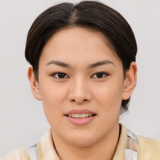 Joyful asian young-adult female with short  brown hair and brown eyes