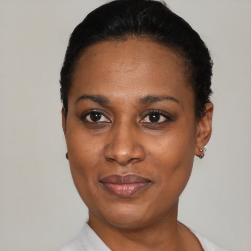 Joyful black young-adult female with short  black hair and brown eyes