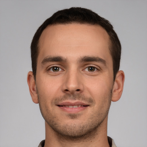 Joyful white young-adult male with short  brown hair and brown eyes