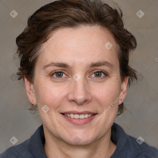 Joyful white adult female with medium  brown hair and blue eyes