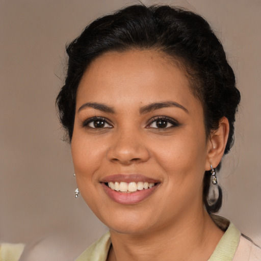 Joyful latino young-adult female with medium  brown hair and brown eyes