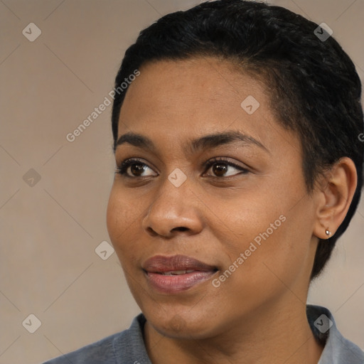 Joyful black young-adult female with short  black hair and brown eyes