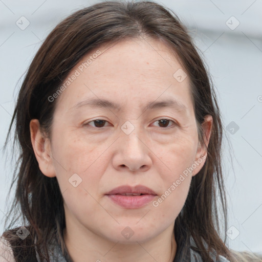 Joyful white adult female with long  brown hair and brown eyes