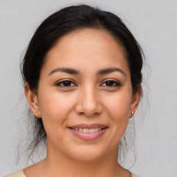 Joyful latino young-adult female with medium  brown hair and brown eyes