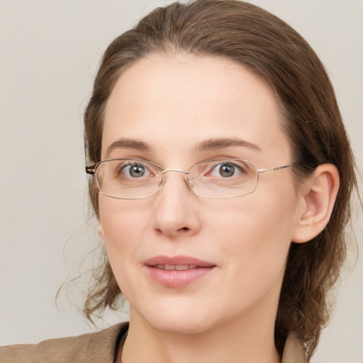 Joyful white young-adult female with medium  brown hair and green eyes