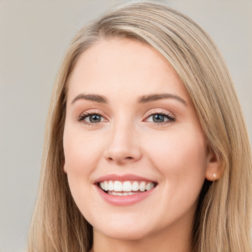 Joyful white young-adult female with long  brown hair and blue eyes