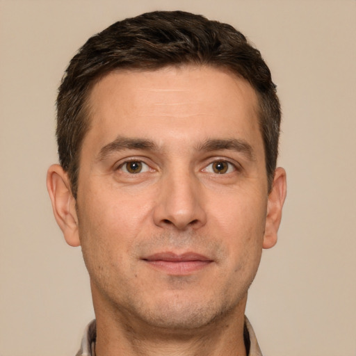 Joyful white adult male with short  brown hair and brown eyes