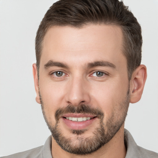 Joyful white young-adult male with short  brown hair and brown eyes