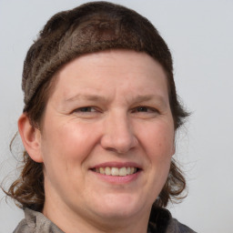 Joyful white adult female with medium  brown hair and blue eyes