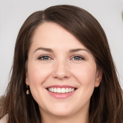 Joyful white young-adult female with long  brown hair and brown eyes