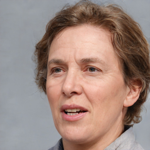 Joyful white middle-aged female with medium  brown hair and brown eyes