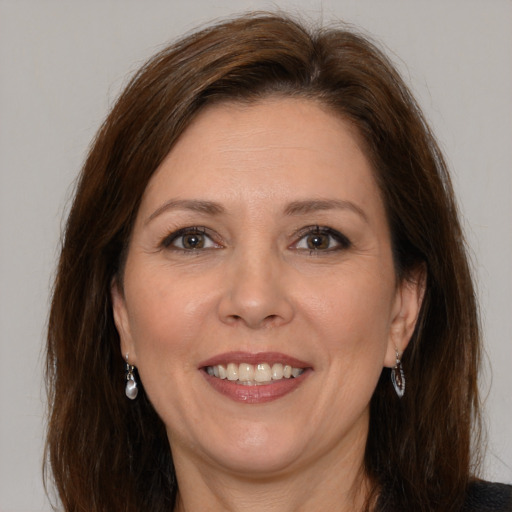 Joyful white adult female with medium  brown hair and brown eyes