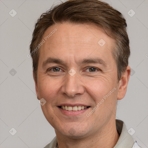 Joyful white adult male with short  brown hair and grey eyes