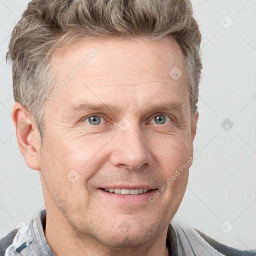 Joyful white adult male with short  brown hair and grey eyes