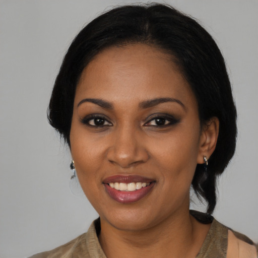 Joyful black young-adult female with medium  black hair and brown eyes
