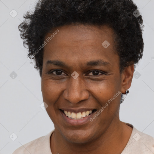 Joyful black young-adult male with short  brown hair and brown eyes