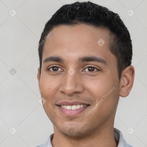 Joyful latino young-adult male with short  black hair and brown eyes