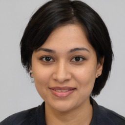 Joyful latino young-adult female with medium  black hair and brown eyes