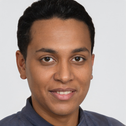 Joyful latino young-adult male with short  brown hair and brown eyes