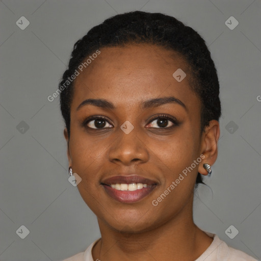 Joyful black young-adult female with short  black hair and brown eyes