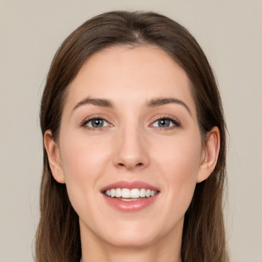 Joyful white young-adult female with long  brown hair and grey eyes