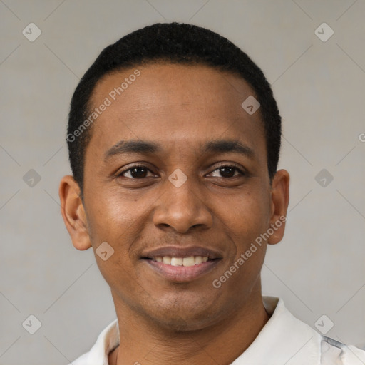 Joyful latino young-adult male with short  black hair and brown eyes