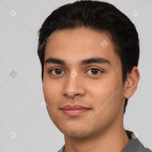 Joyful white young-adult male with short  black hair and brown eyes