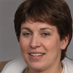 Joyful white adult female with medium  brown hair and brown eyes