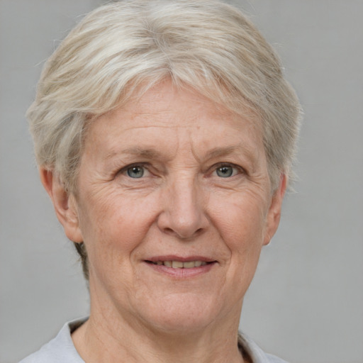 Joyful white middle-aged female with short  gray hair and grey eyes