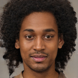 Joyful black young-adult male with short  brown hair and brown eyes