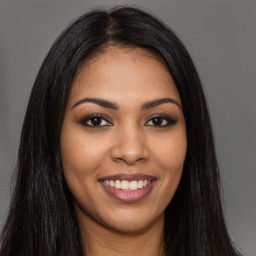 Joyful latino young-adult female with long  brown hair and brown eyes