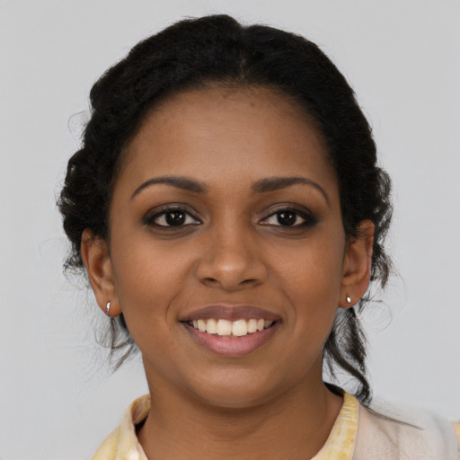 Joyful black young-adult female with medium  brown hair and brown eyes