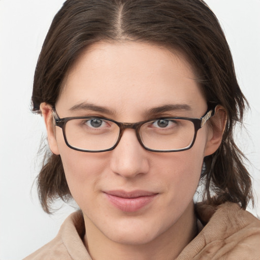 Joyful white young-adult female with medium  brown hair and grey eyes