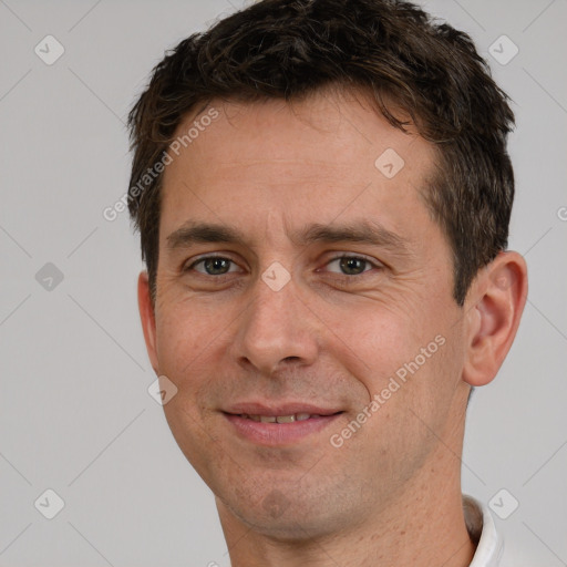 Joyful white adult male with short  brown hair and brown eyes