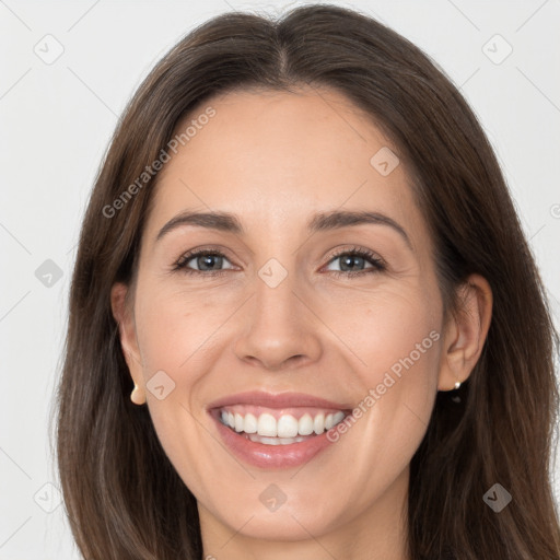 Joyful white adult female with long  brown hair and brown eyes