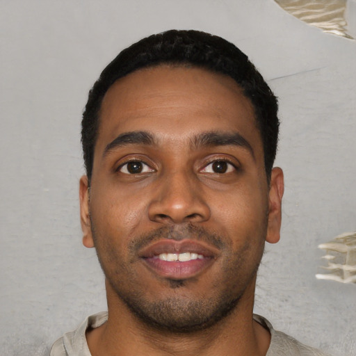 Joyful black young-adult male with short  black hair and brown eyes
