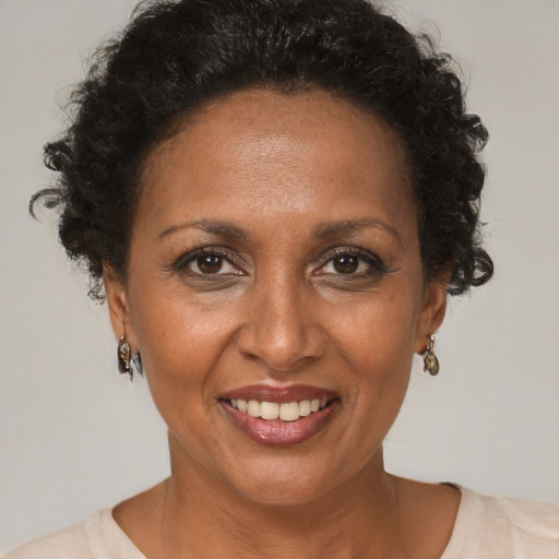 Joyful black adult female with short  brown hair and brown eyes